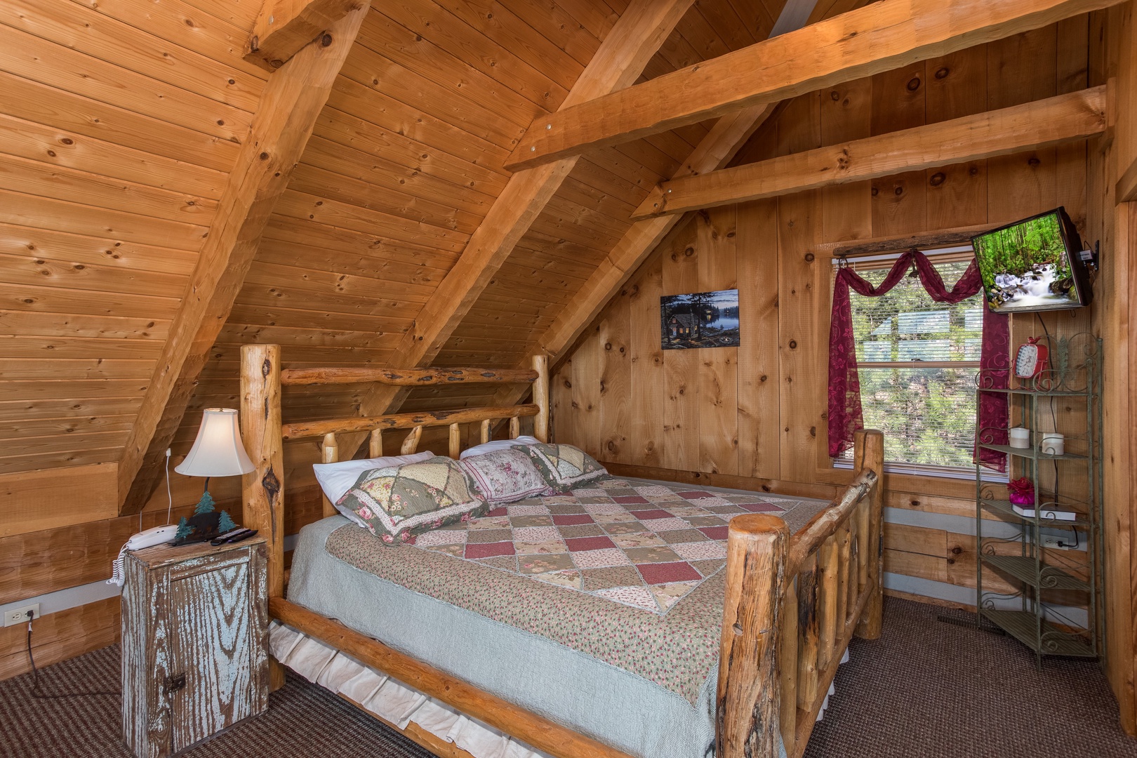 King log bed in the loft at Mountain Glory, a 1 bedroom cabin rental located in Pigeon Forge