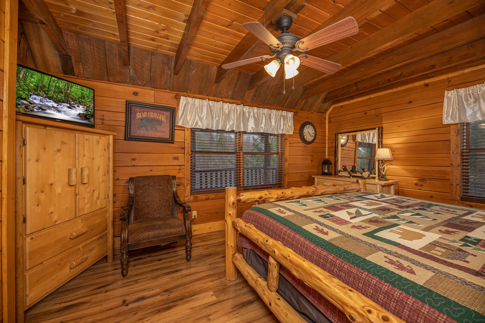Armoire, TV, and chair in a bedroom at Pigeon Forge Pleasures, a 3 bedroom cabin rental located in Pigeon Forge