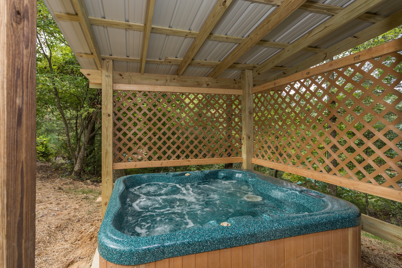 Hot tub on a covered deck at Bird's Eye View, a 2-bedroom cabin rental located in Gatlinburg