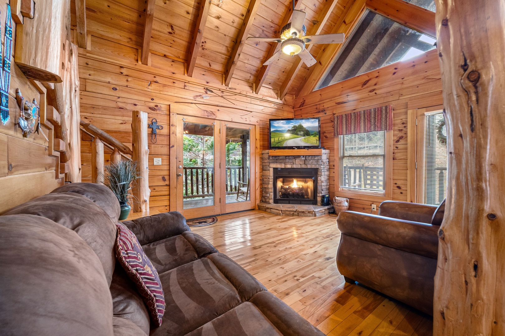 Living room with fireplace and TV at Alpine Sondance, a 2 bedroom cabin rental located in Pigeon Forge
