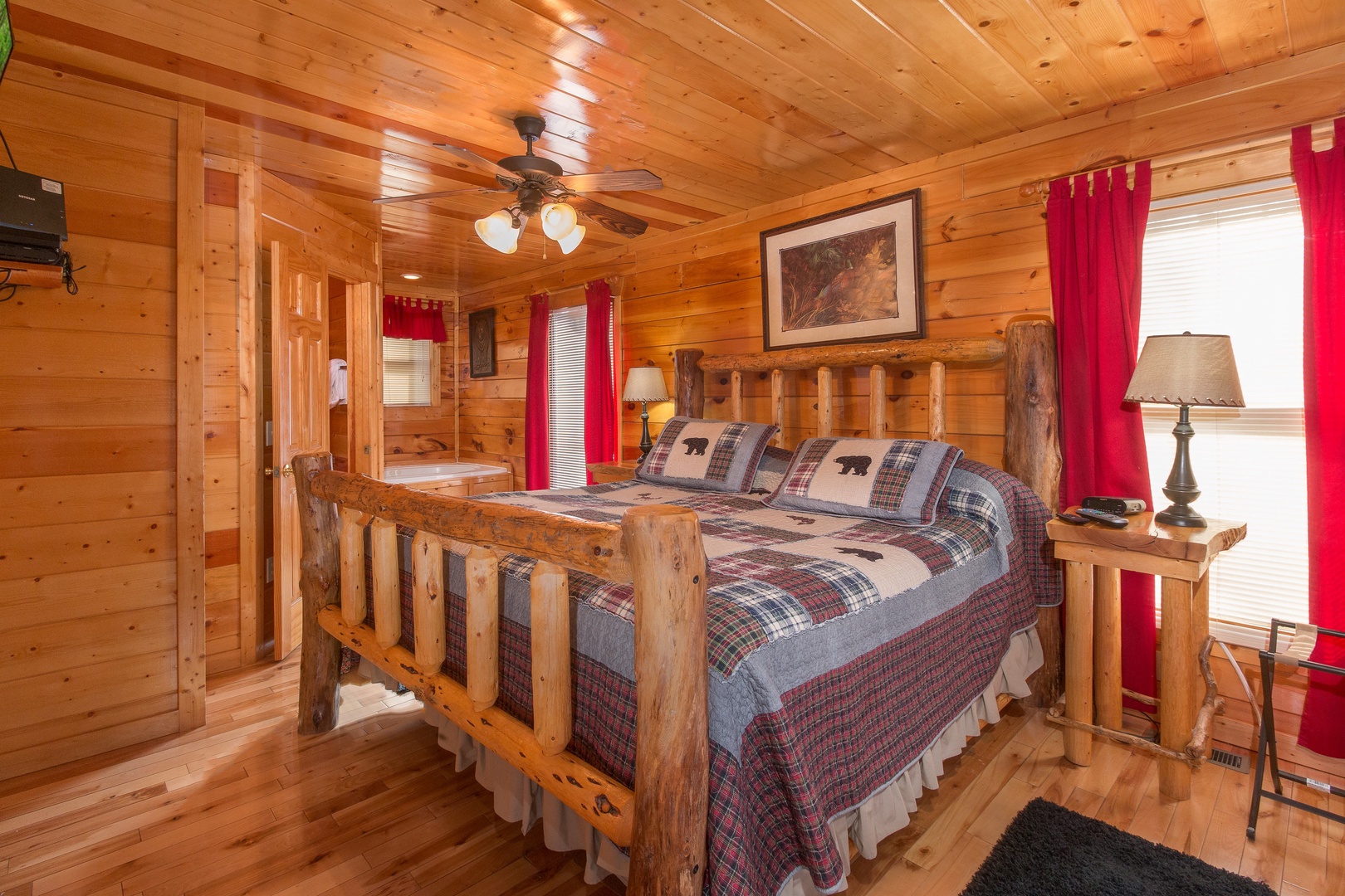 Bedroom with a log bed, night stands, and lamps at Country Bear's Getaway, a 3-bedroom cabin rental located in Gatlinburg