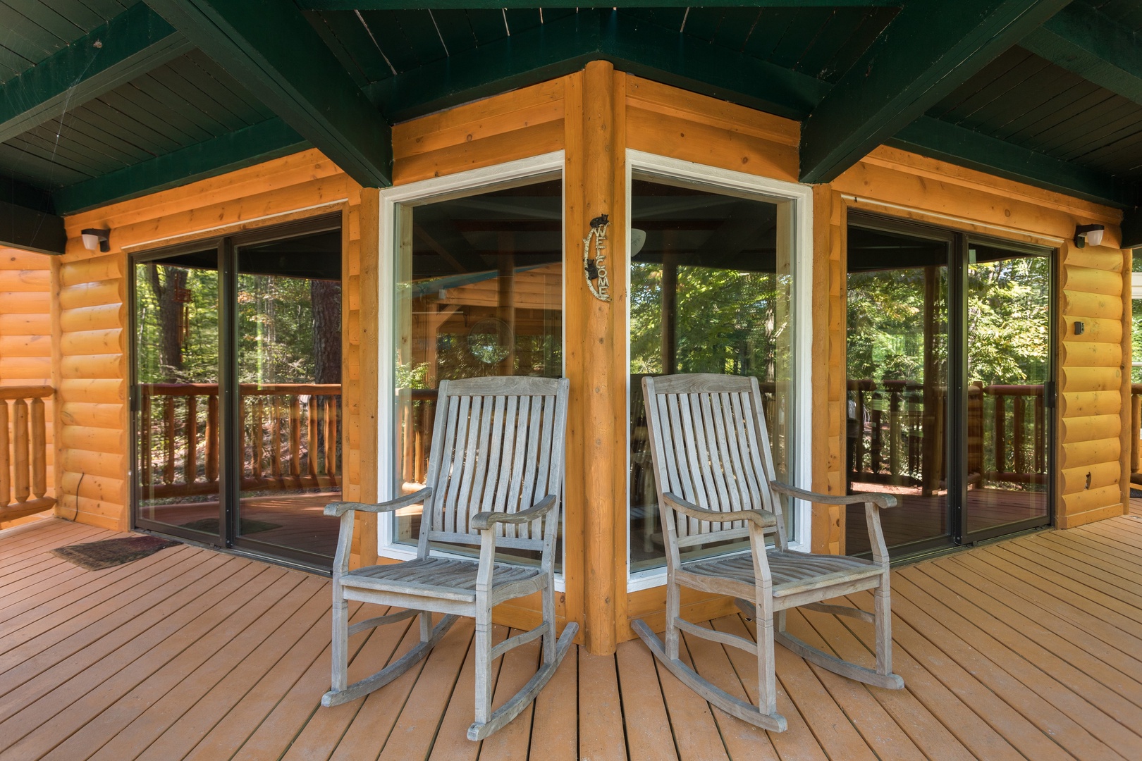 Rocking chairs on a covered deck at Forever Country, a 3 bedroom cabin rental located in Pigeon Forge