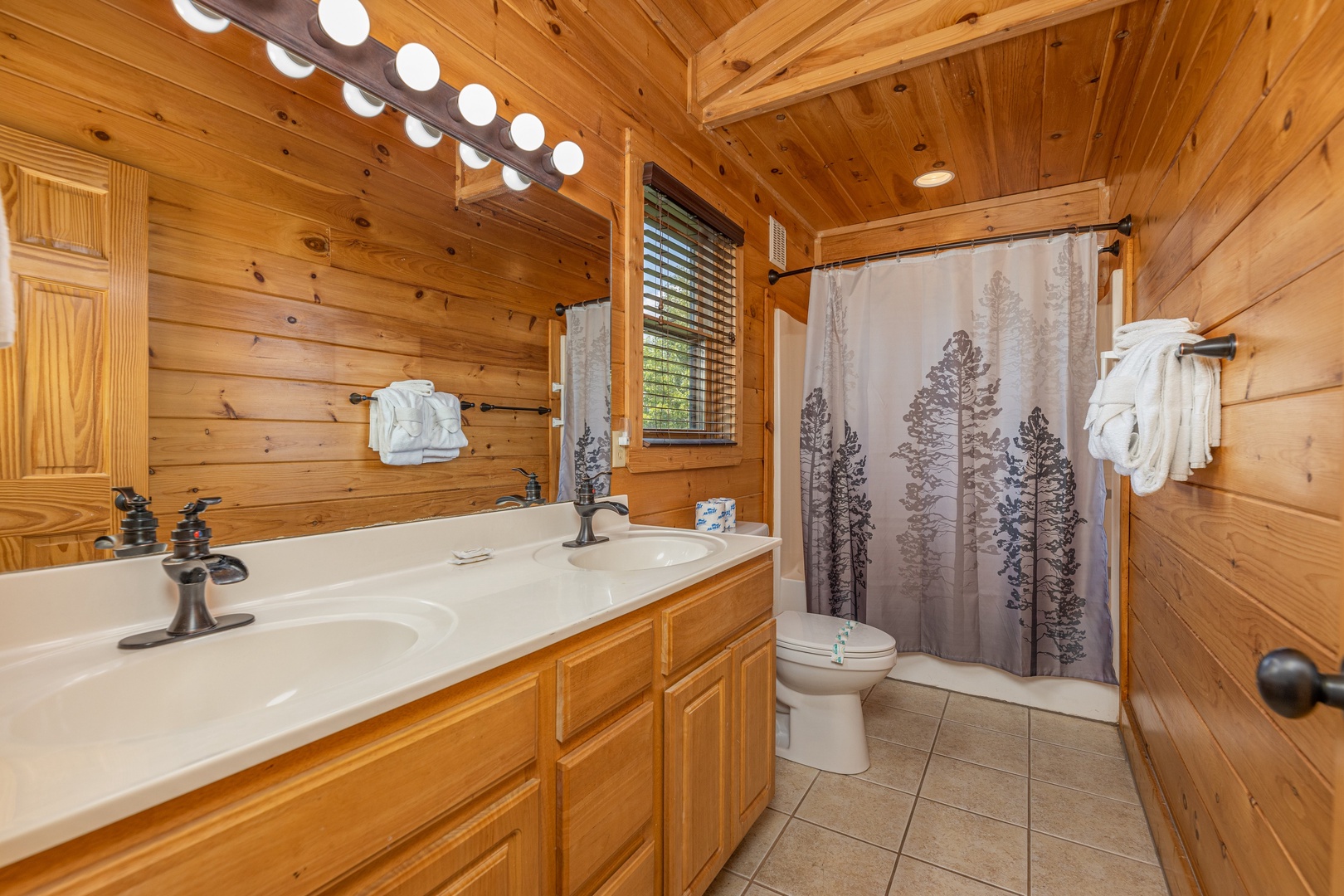 Master bath with shower and bathtub at Loving Every Minute, a 5 bedroom cabin rental located in Pigeon Forge