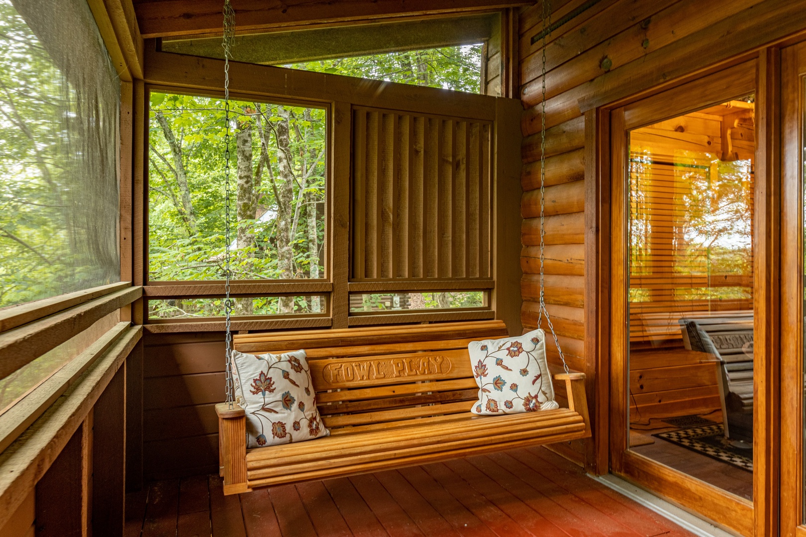 Porch swing on the screened deck at Fowl Play, a 1 bedroom cabin rental located in Pigeon Forge