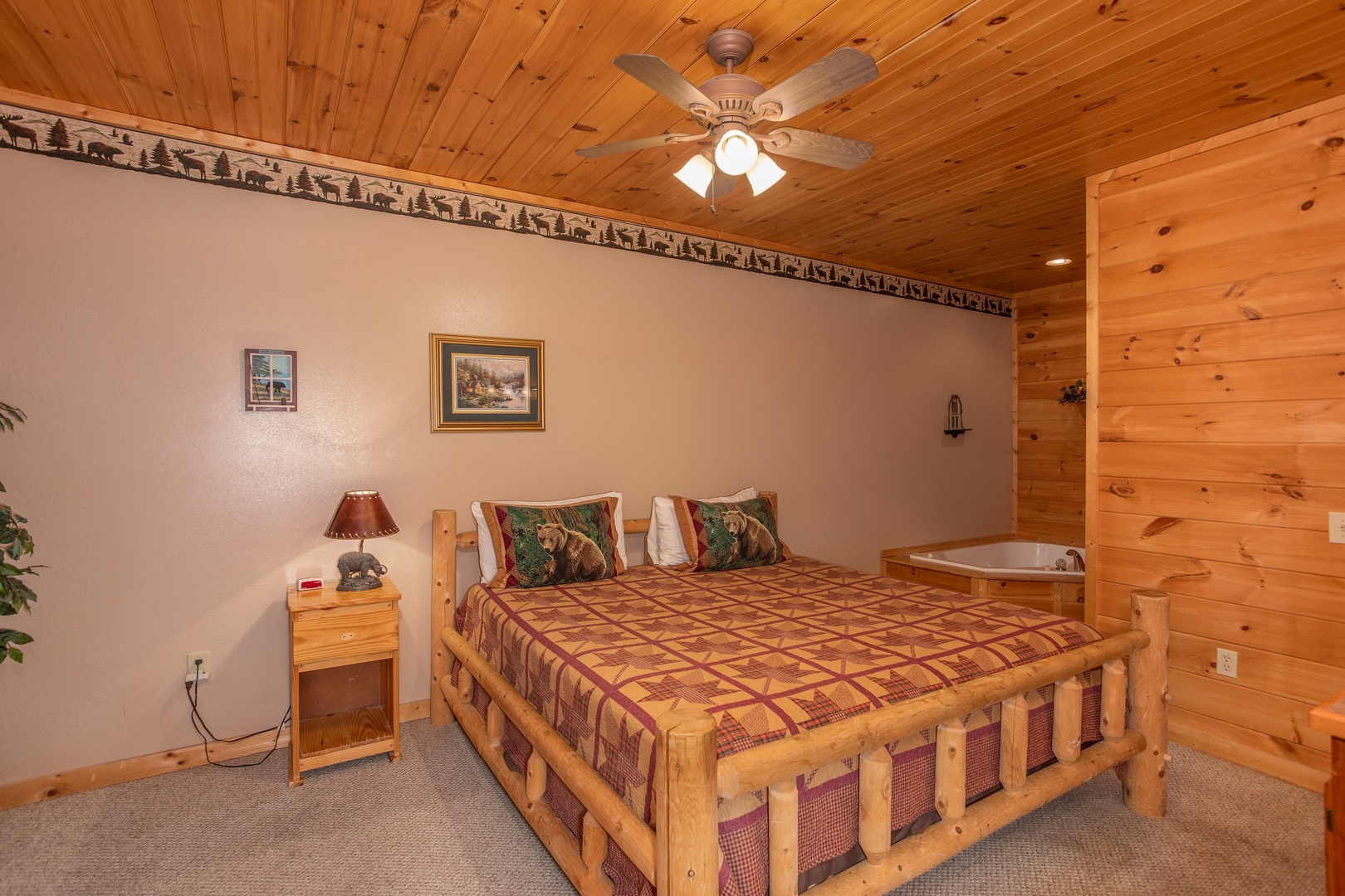 Bedroom with king-sized bed and jacuzzi at Bearly in the Mountains, a 5-bedroom cabin rental located in Pigeon Forge