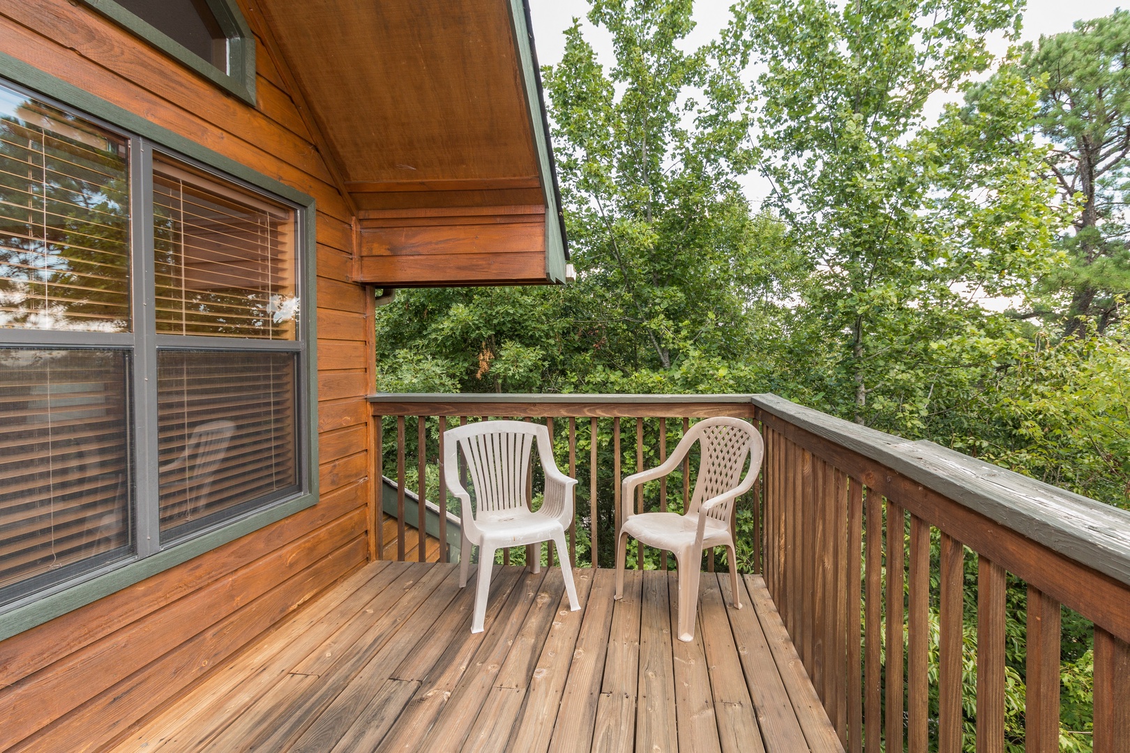 Deck with chairs at Stones Throw, a 4 bedroom cabin rental located in Pigeon Forge