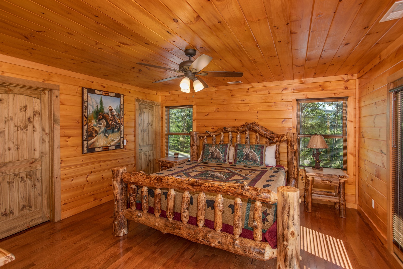 Bedroom with a king-sized log bed at Four Seasons Palace, a 5-bedroom cabin rental located in Pigeon Forge