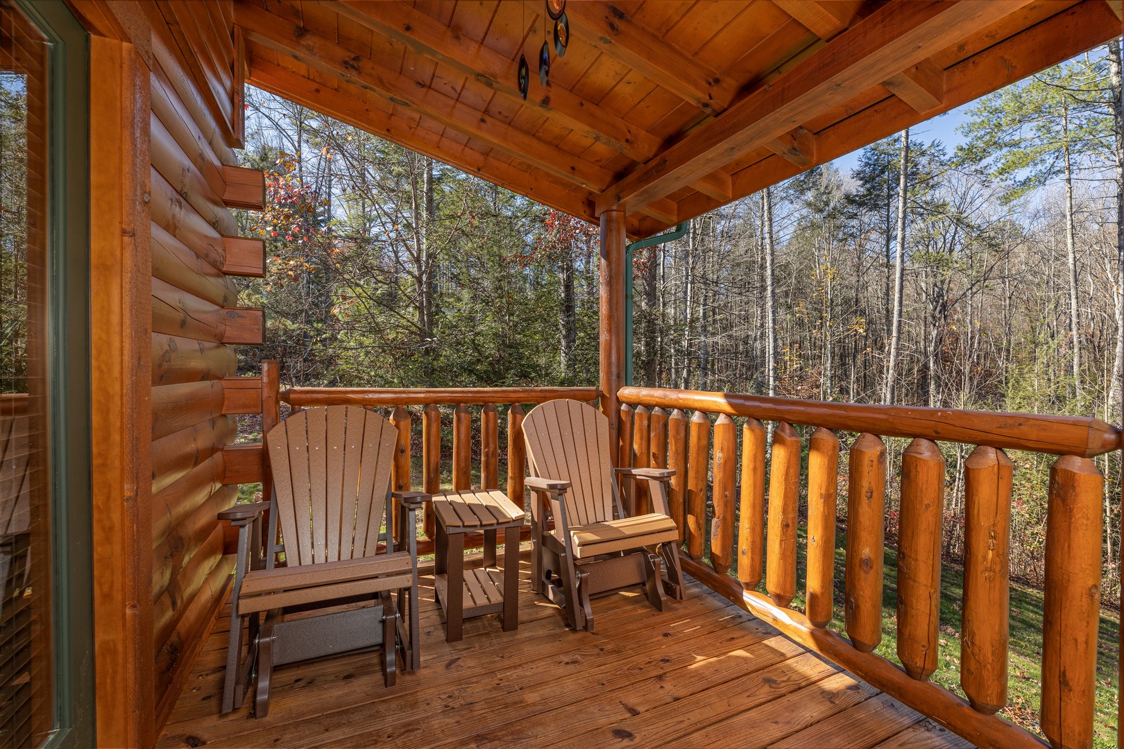 Two adirondack chairs on a covered deck at 3 Crazy Cubs, a 5 bedroom cabin rental located in Pigeon Forge