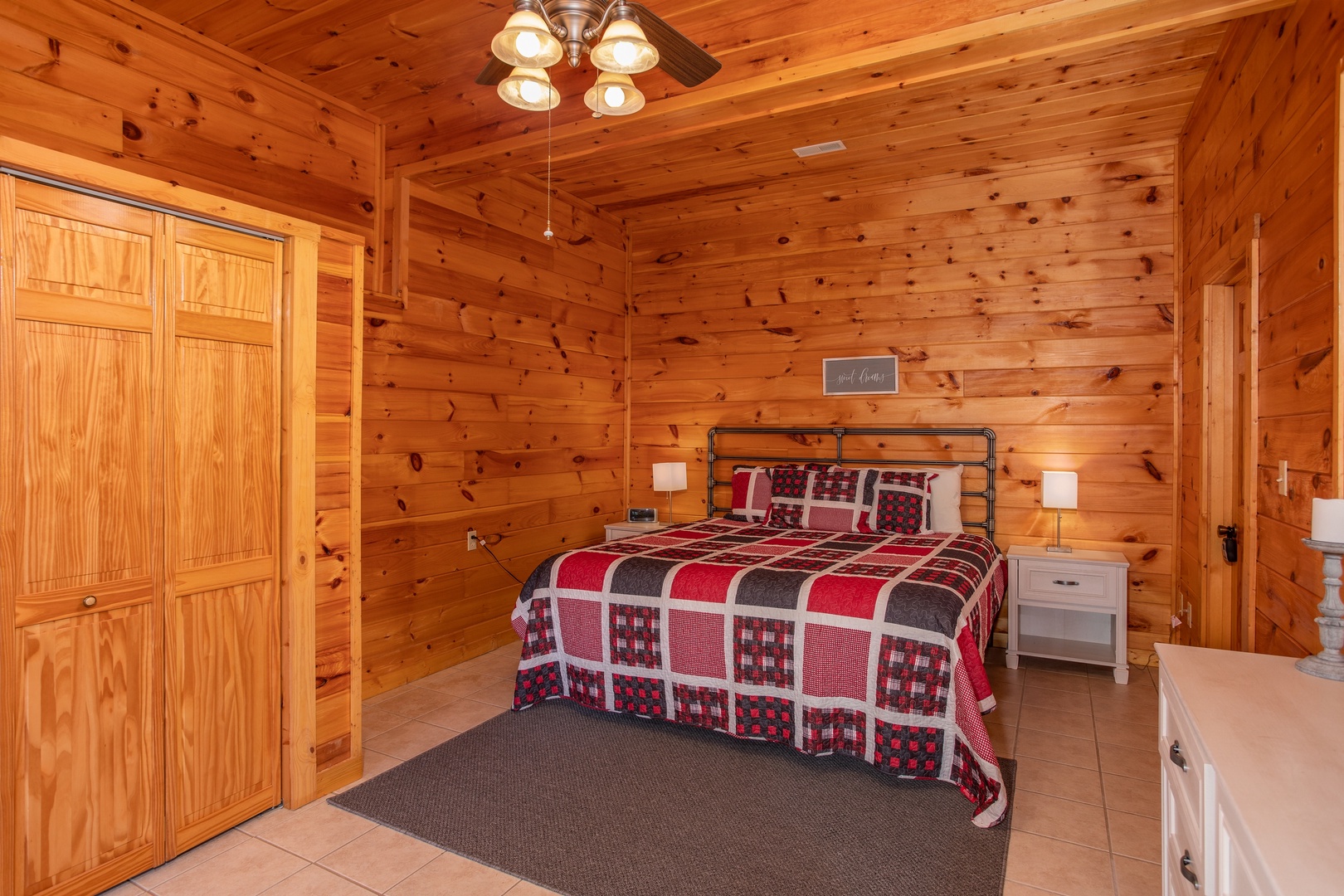 Queen bed with two end tables at Cabin Fever, a 4-bedroom cabin rental located in Pigeon Forge