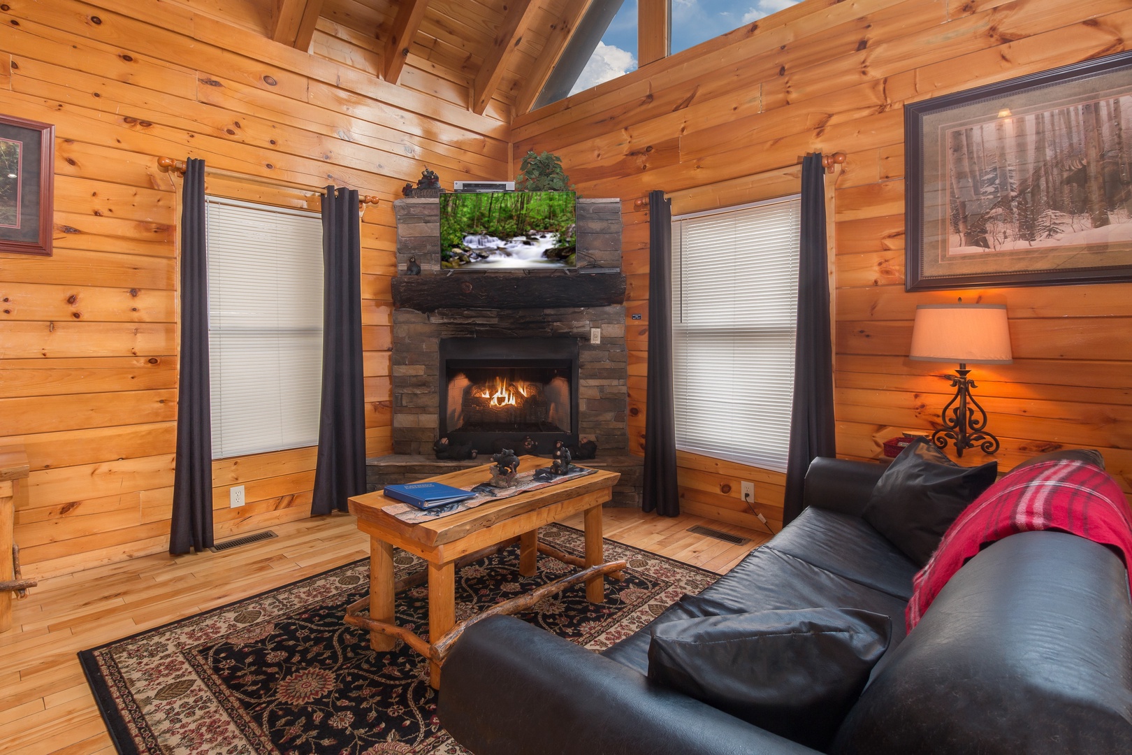 Fireplace and TV in a living room at Country Bear's Getaway, a 3-bedroom cabin rental located in Gatlinburg