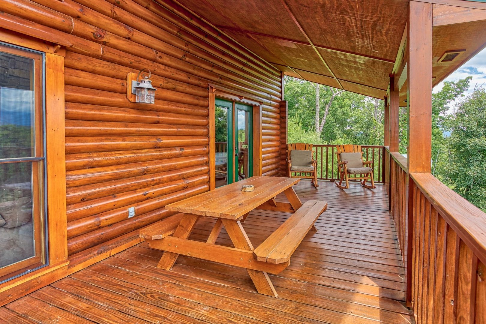 Picnic table on the covered deck at I Do Love Views, a 3 bedroom cabin rental located in Pigeon Forge