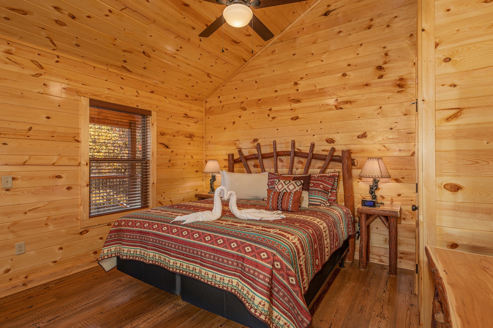 Bedroom with king bed, two night stands and lamps at Pinot Splash, a 4 bedroom cabin rental located in Gatlinburg