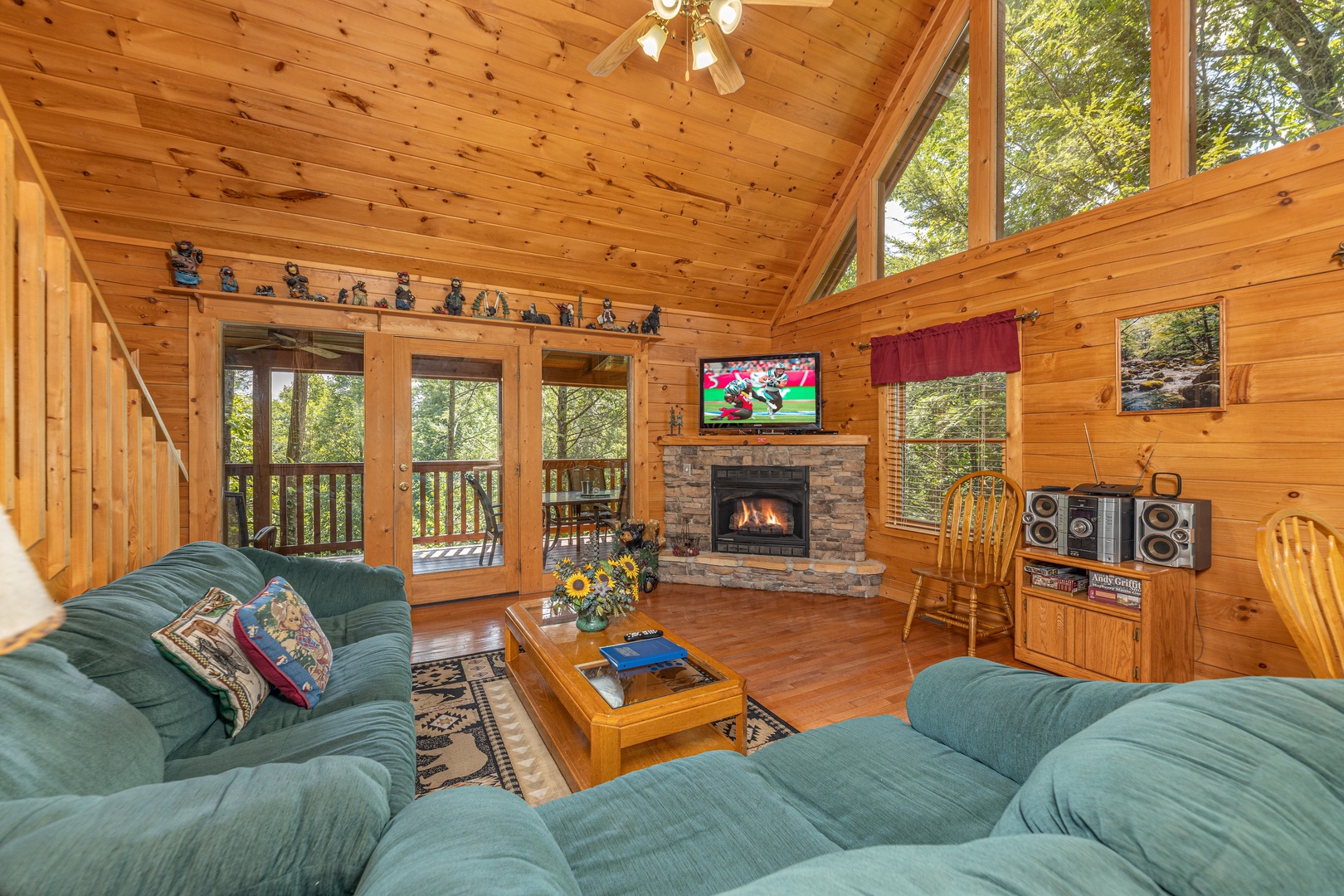 Living room with sofa, loveseat, fireplace, and TV at Cub's Crossing, a 3 bedroom cabin rental located in Gatlinburg