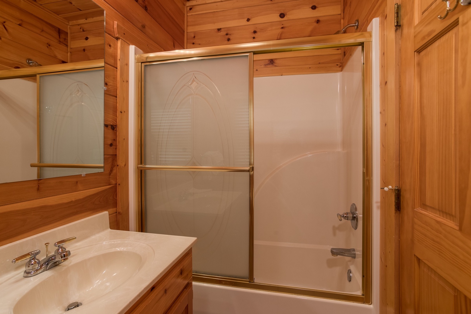 Bathroom with a tub and shower at Howlin' in the Smokies, a 2 bedroom cabin rental located in Pigeon Forge