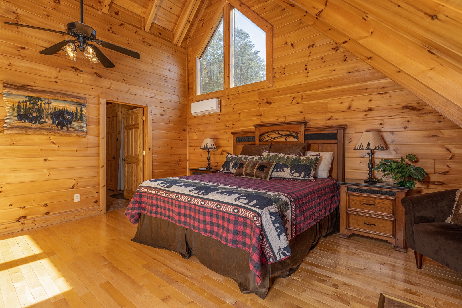 Bedroom with king bed, two night stands, and lamps at Bears Don't Bluff, a 3 bedroom cabin rental located in Pigeon Forge