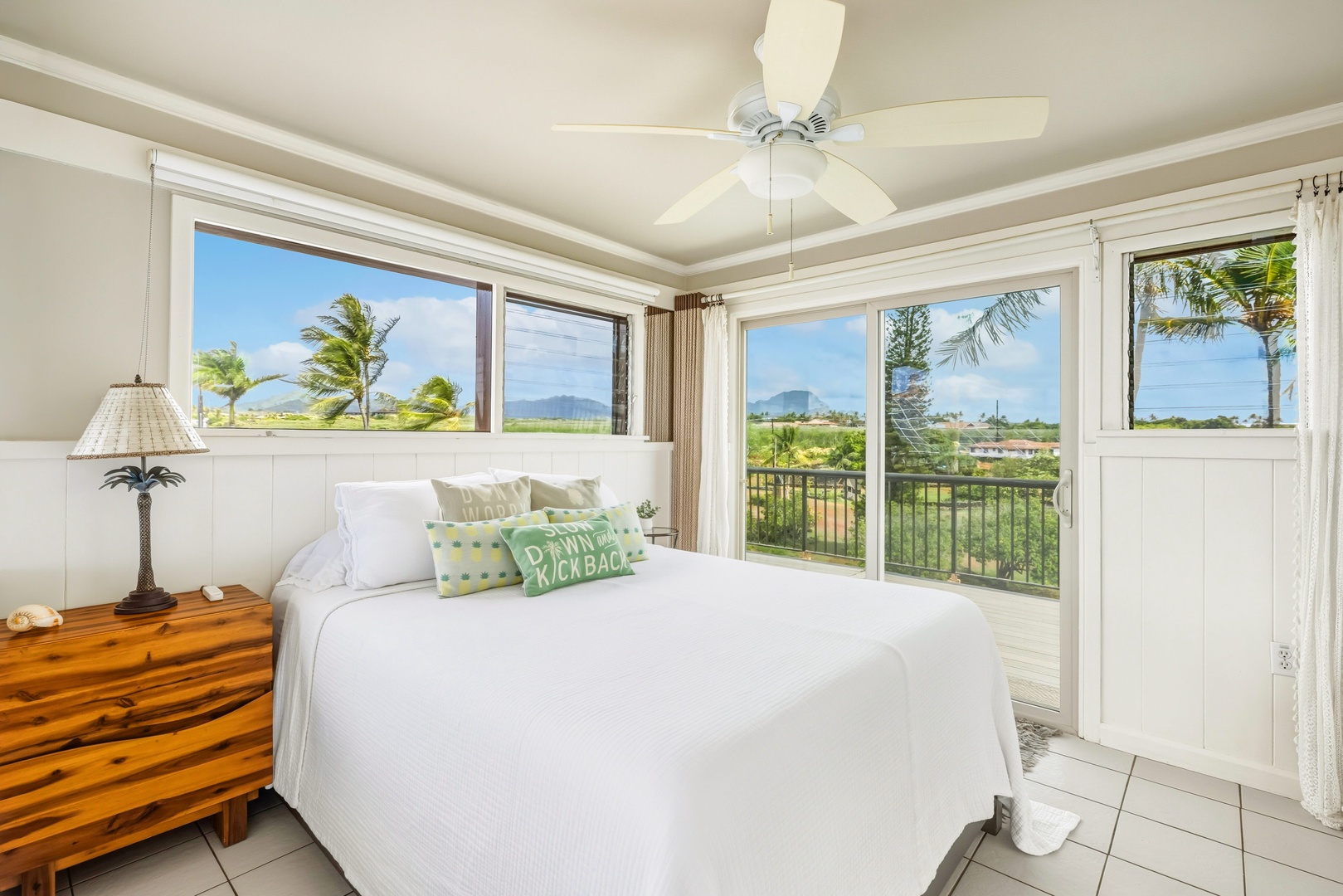 Wake up to stunning tropical views from your peaceful bedroom sanctuary, where swaying palms and distant mountains greet you each morning.