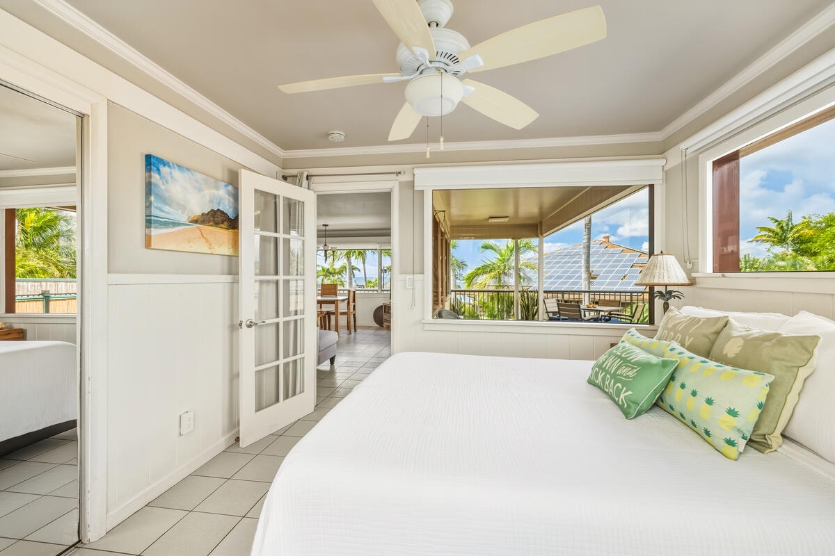 Wake up to tropical breezes in your bright bedroom with palm views and French doors opening to your private lanai.
