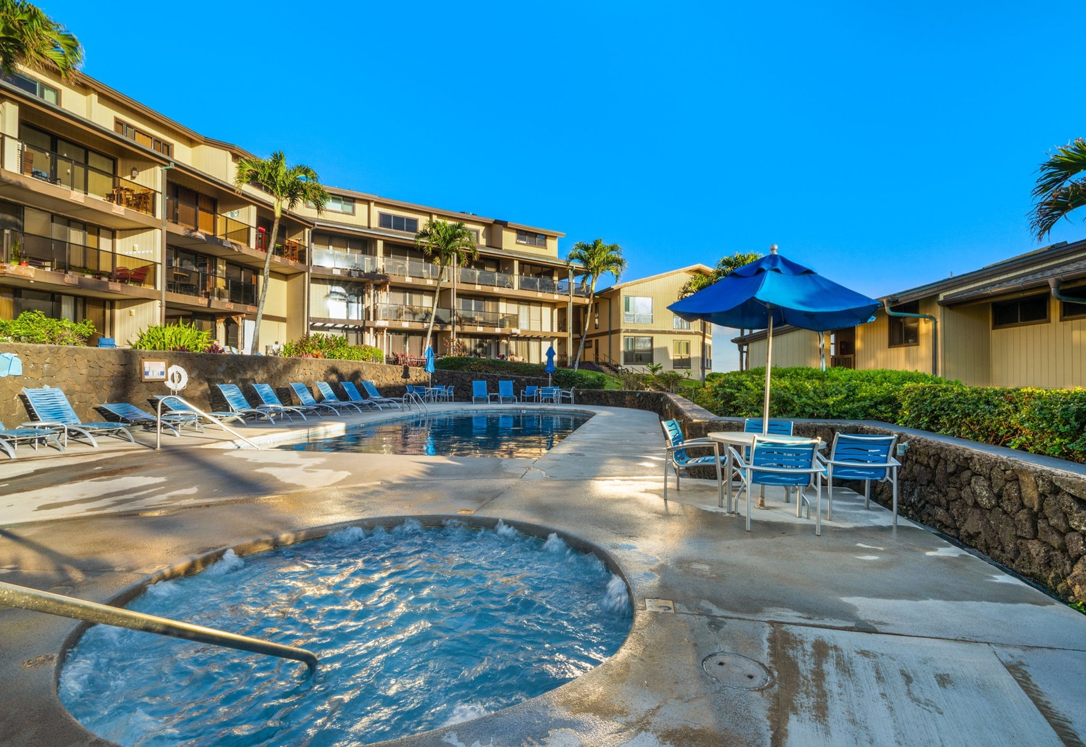 Soak in the sparkling hot tub or lounge poolside under swaying palms at this tropical oasis, framed by your resort-style accommodations and endless blue skies.