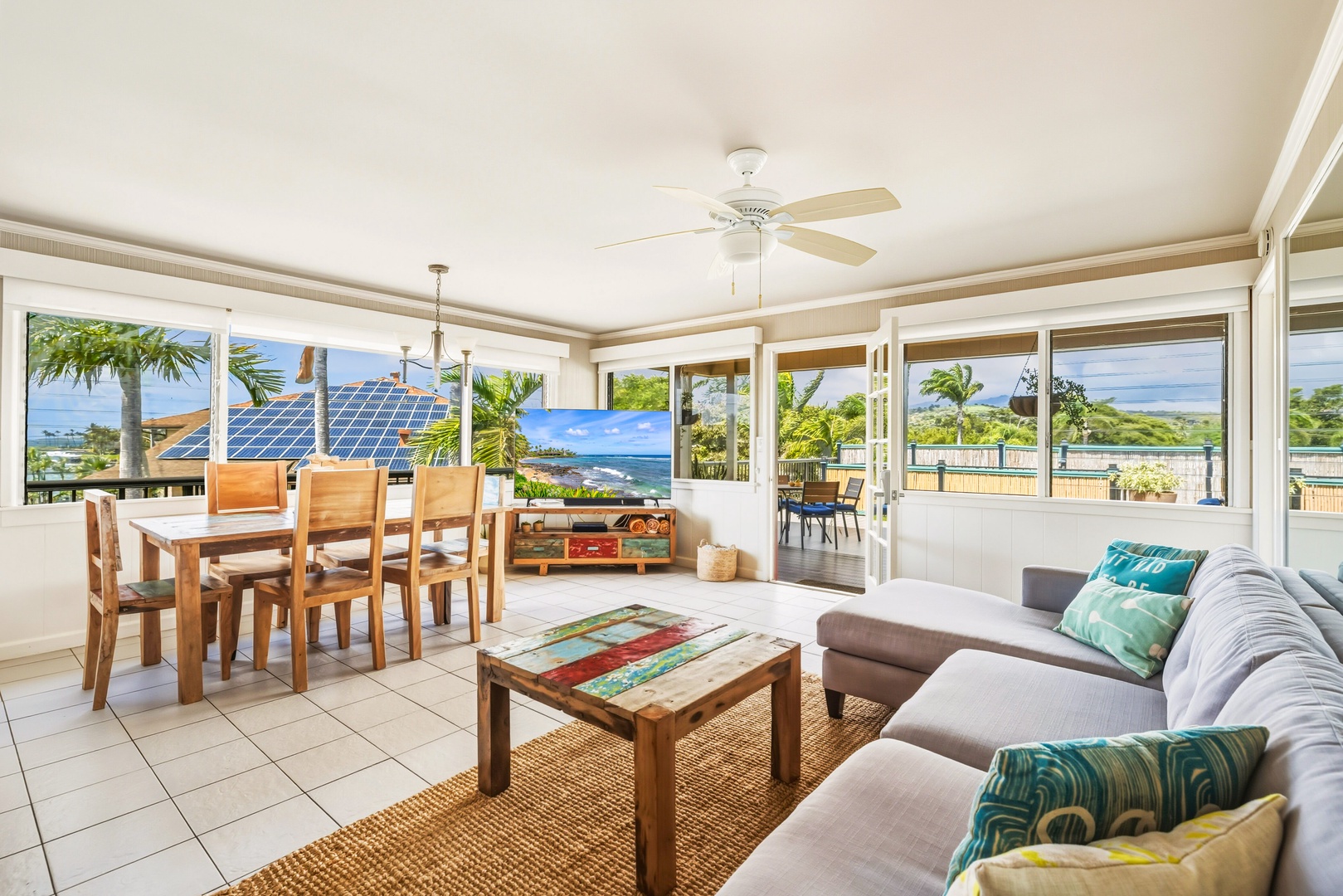 Relax in your bright, open living space with panoramic ocean views through floor-to-ceiling windows and tropical breezes from your ceiling fan.
