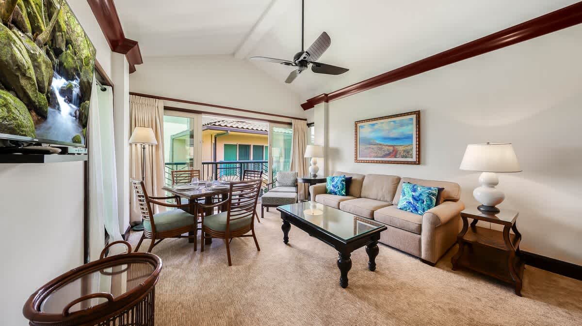 Picture yourself relaxing in this bright, airy living space with warm tropical touches. Enjoy your morning coffee at the dining table while the ceiling fan keeps you cool, or unwind on the plush sofa after exploring the area.