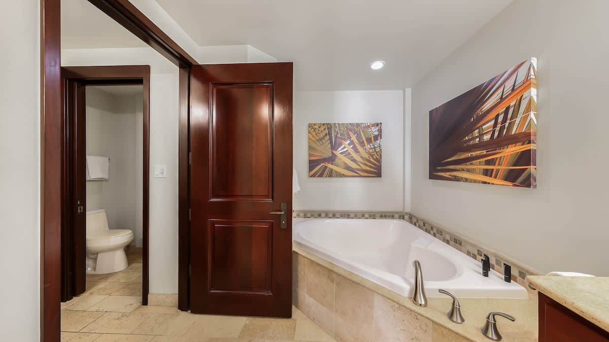 Sink into your deep soaking tub after a day of exploring, with warm lighting and art that creates a peaceful sanctuary for unwinding.