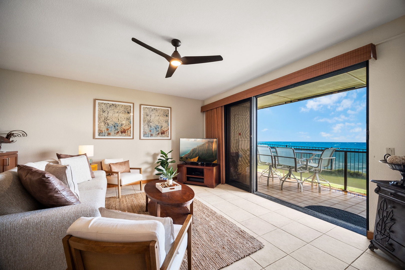 Unwind in your bright, airy living room with stunning ocean views just beyond your private balcony. Coastal-inspired décor and comfortable seating set the perfect stage for your beachside escape.