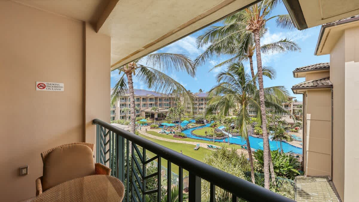 Step onto your private balcony and soak in stunning views of swaying palms, lush grounds, and a sparkling pool—your tropical escape awaits just beyond the railing.