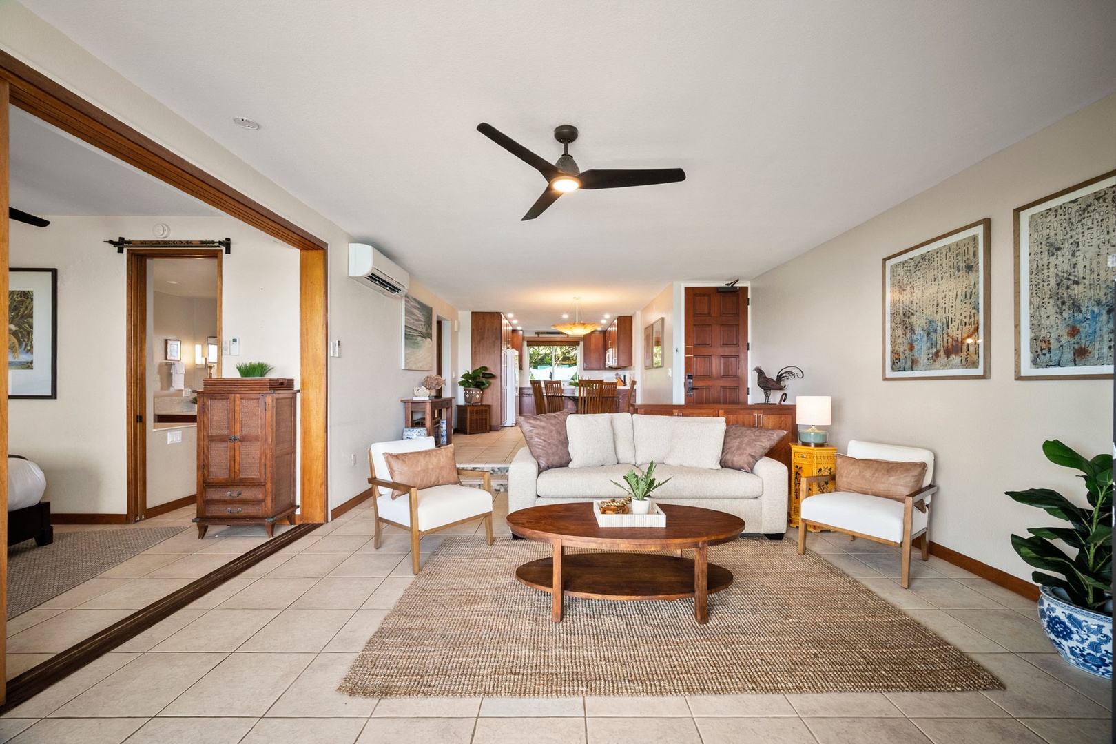 Settle into your spacious living area with plush seating, warm wood accents, and tropical touches—a serene retreat where you can unwind after exploring.