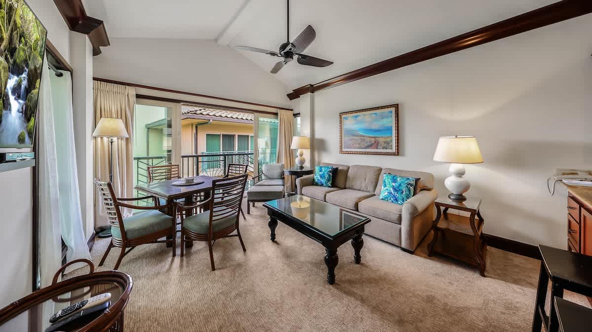 Relax in your spacious living area with vaulted ceilings, elegant wood beams, and a private balcony where you can unwind after a day of adventure.