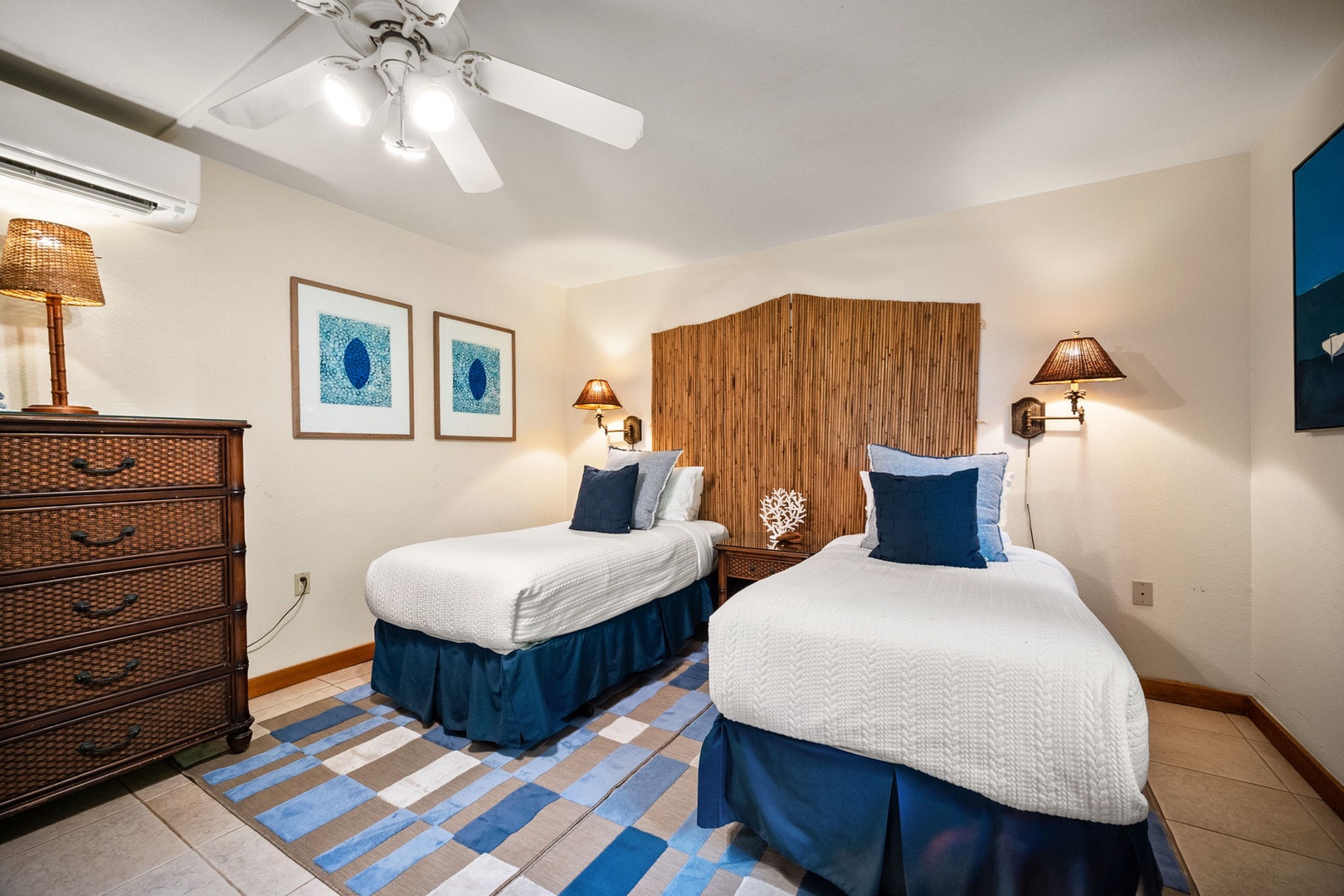 Sink into plush twin beds styled with coastal blues and wicker accents, cooled by both ceiling fan and AC, for your most restful island escape.