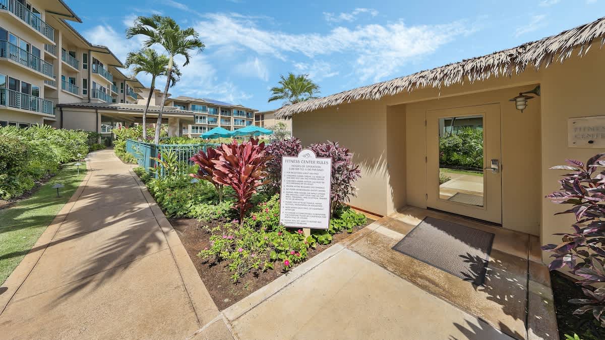A tropical-themed outdoor facility set among lush gardens with vibrant tropical plants, palm trees, and well-maintained pathways connecting the resort buildings.