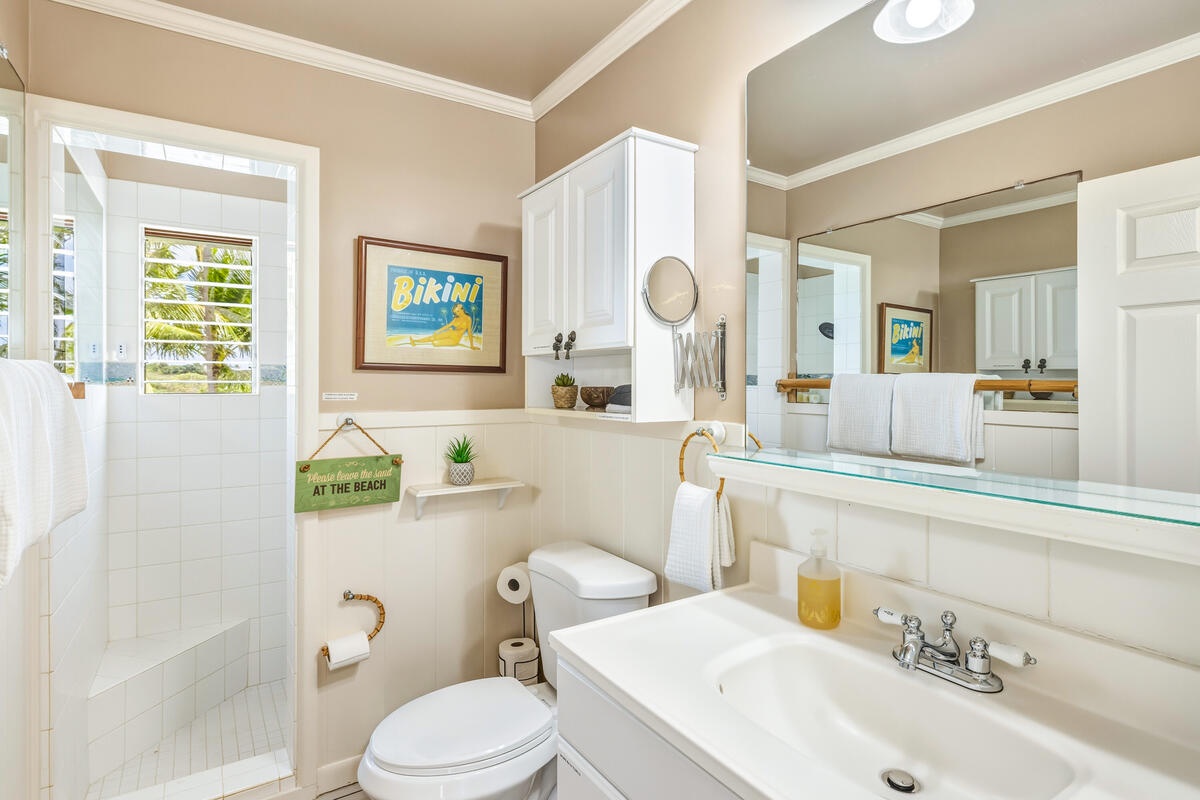 Soak in your private spa-style bathroom with tropical beach vibes and modern amenities for the perfect island getaway refresh.