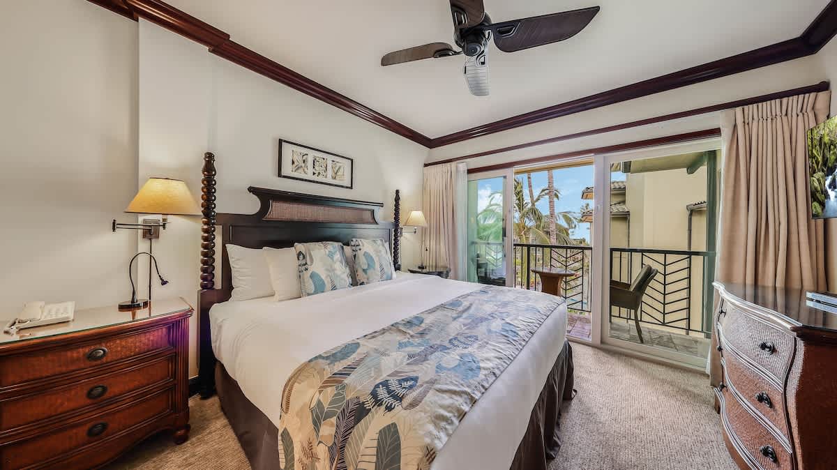 Sink into crisp linens and tropical elegance. Your ceiling fan keeps you cool while French doors open to your private balcony retreat with palm views.