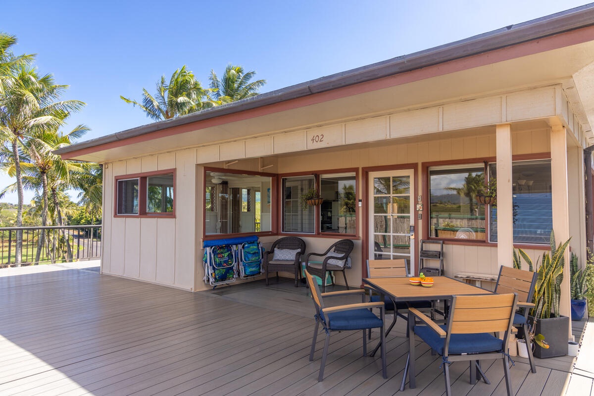 Relax on your private tropical deck with outdoor dining and comfortable seating, surrounded by swaying palms under endless blue skies.