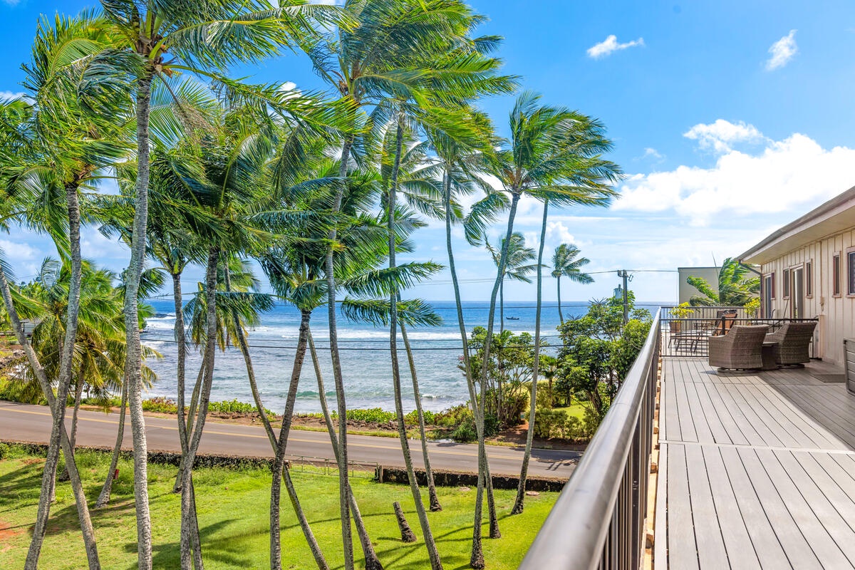 Step onto your private terrace and soak in breathtaking ocean views through swaying palms—your perfect tropical escape awaits.