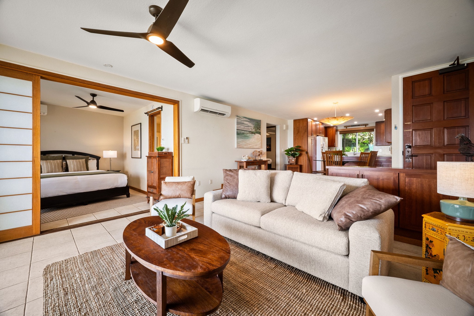 Unwind in your spacious open-plan living area with cozy seating, rich wood accents, and modern ceiling fans. Your bedroom flows seamlessly nearby, creating a relaxing retreat for your getaway.
