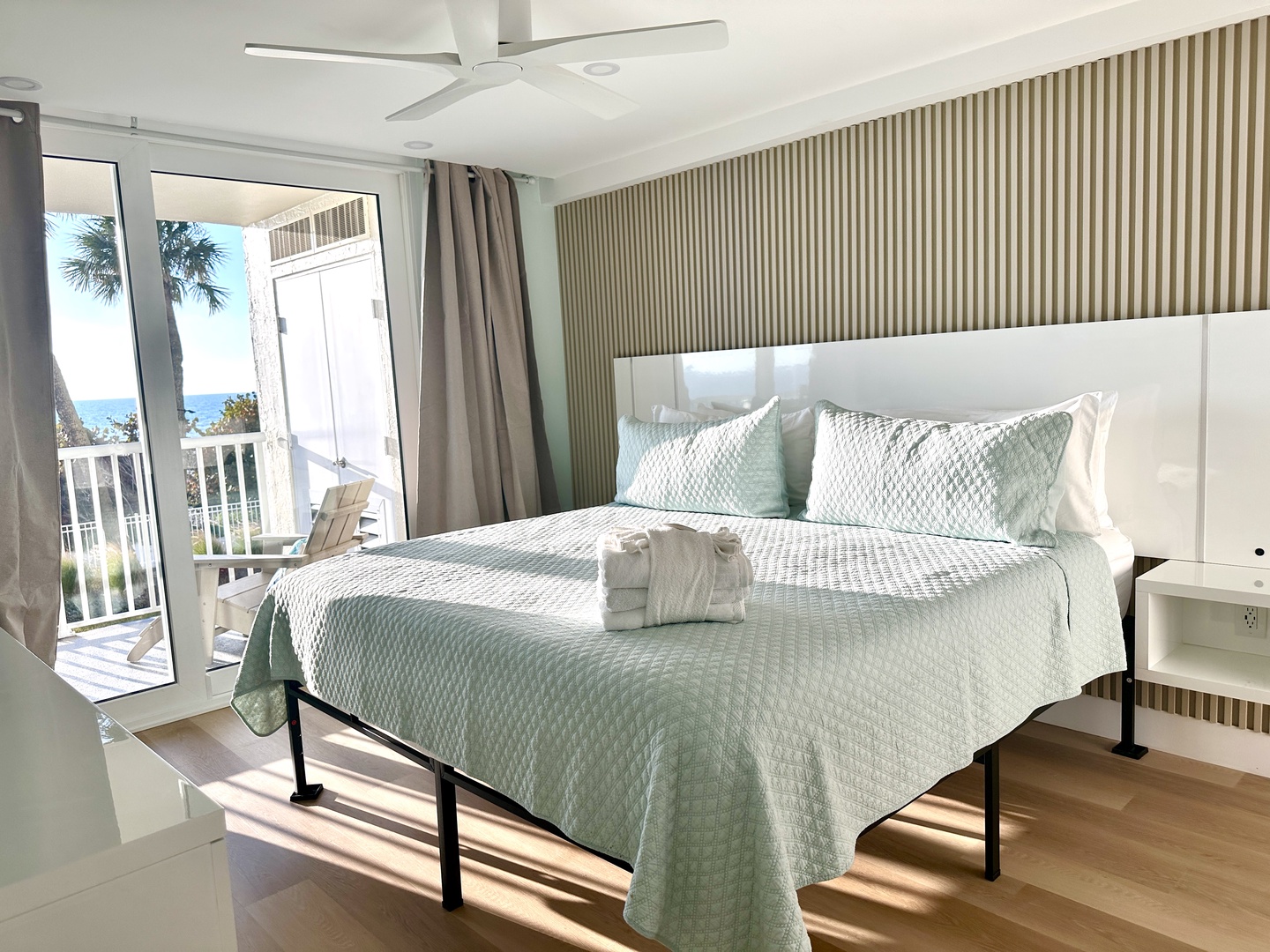 Drift into restful sleep on crisp linens while ocean breezes flow through your private balcony doors and ceiling fan overhead.