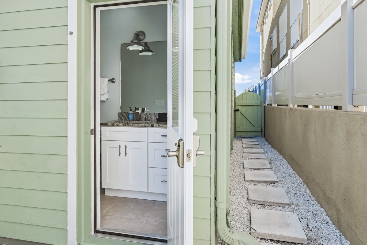 Freshen up in your bright bathroom with modern vanity and granite countertops, then step outside to your private walkway to the beach