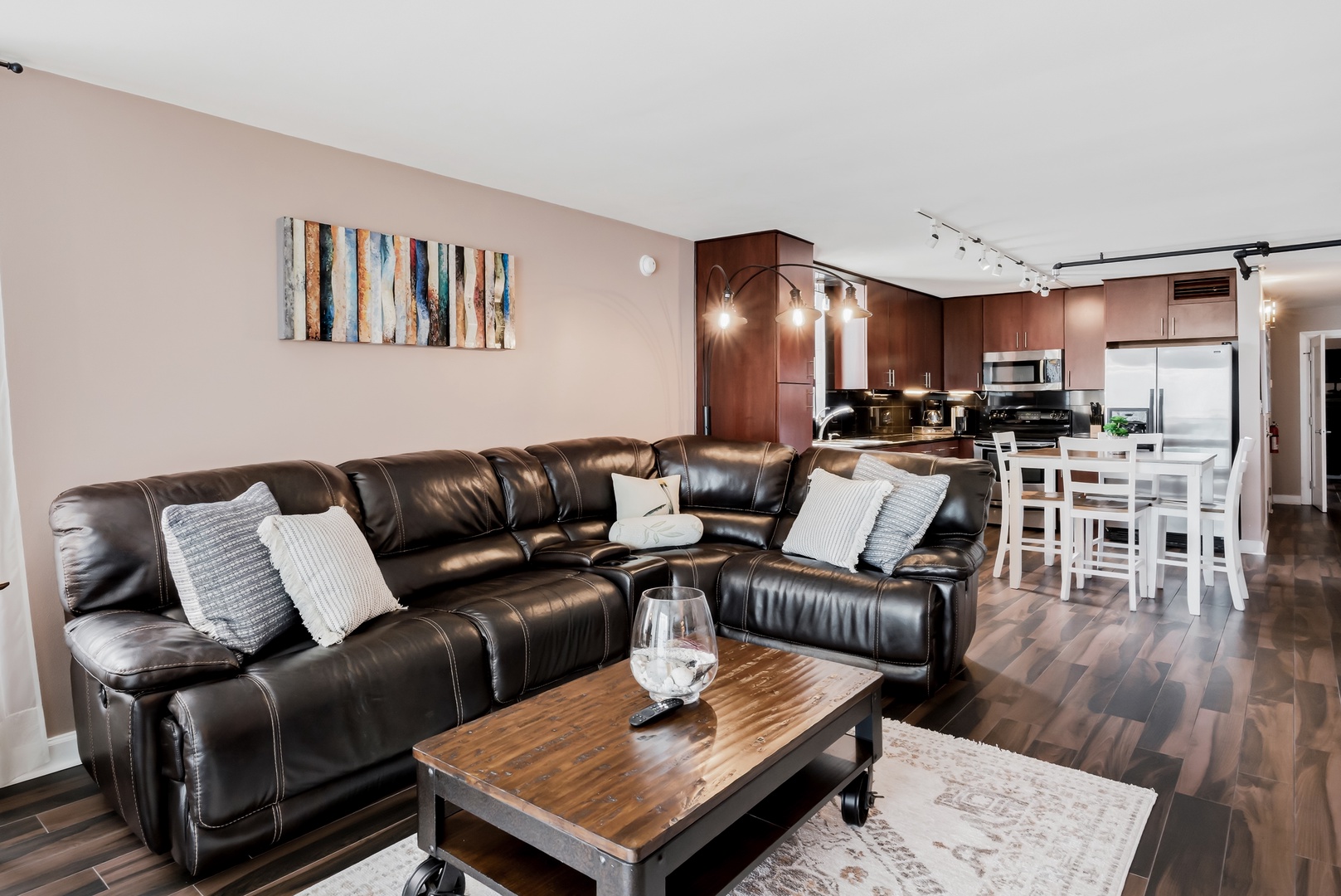 Sink into the plush leather sectional in your open-concept living space, where warm wood tones and modern style invite relaxation after a day of adventure.