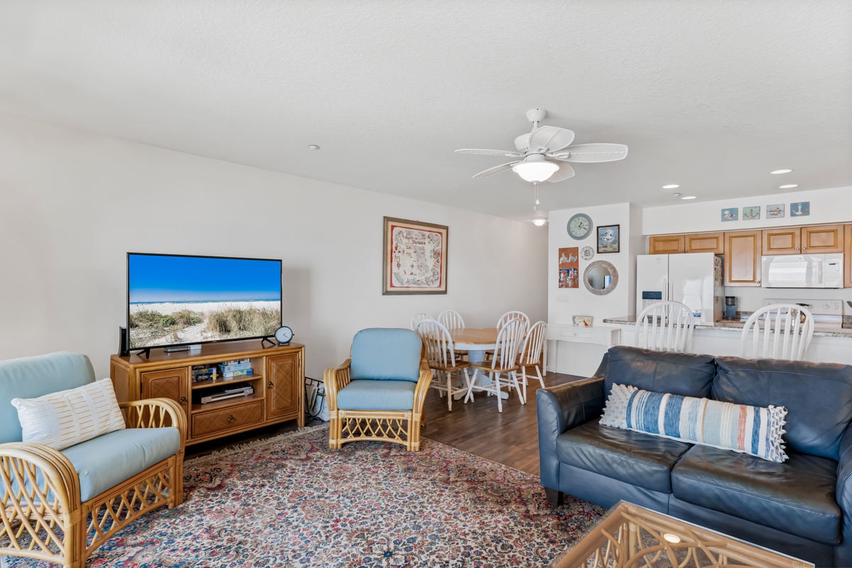 Relax in your spacious open-plan living area with comfortable seating, modern amenities, and coastal charm throughout.