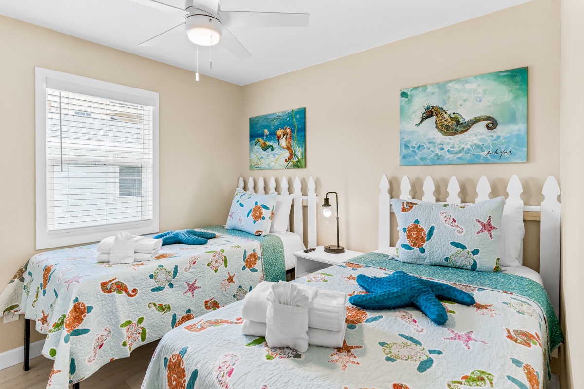 Drift into dreams in this ocean-themed twin bedroom where sea turtle bedding and seahorse artwork create your personal underwater sanctuary.