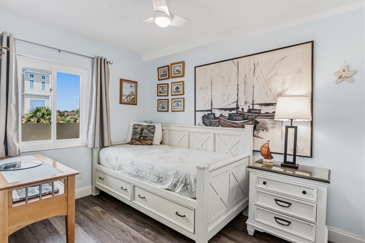 Unwind in your coastal retreat with soft blues and a cozy Twin daybed perfect for afternoon naps or stargazing through the open windows. Plus desk/workspace.