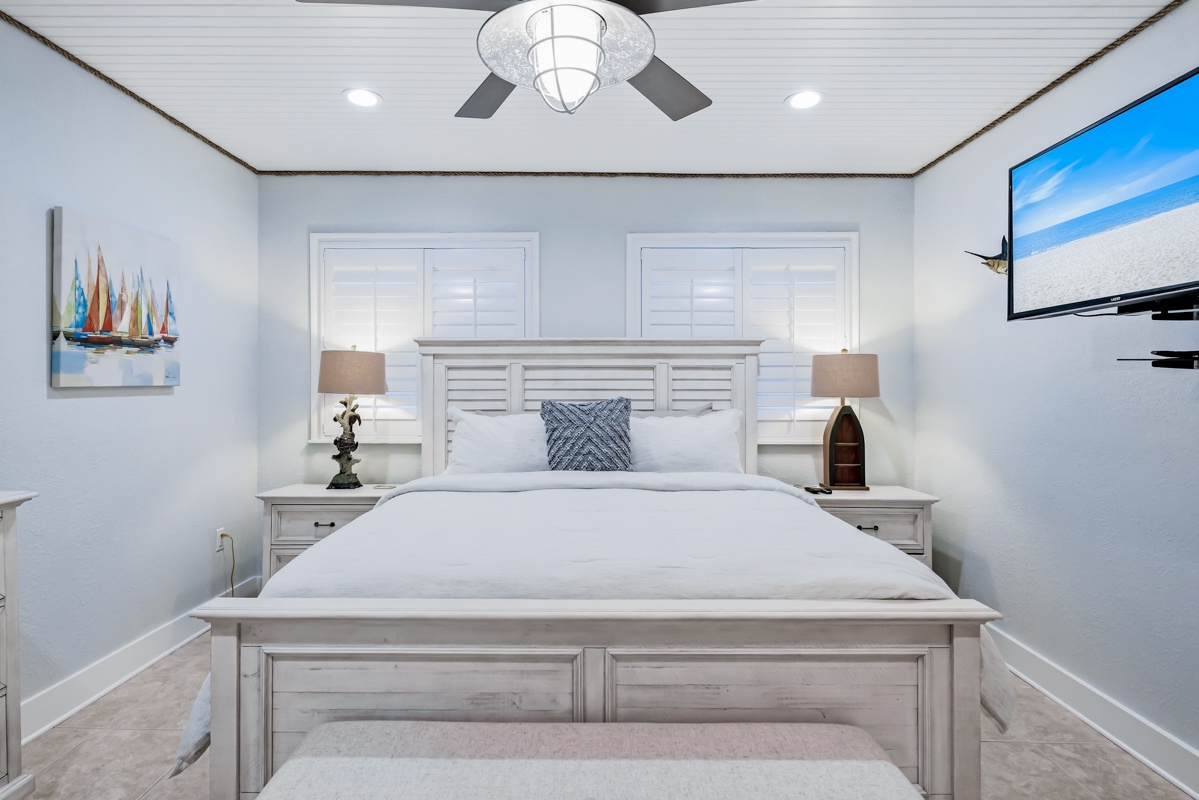 Drift off in this serene bedroom with coastal charm, featuring a plush bed and nautical touches that create your perfect seaside retreat.