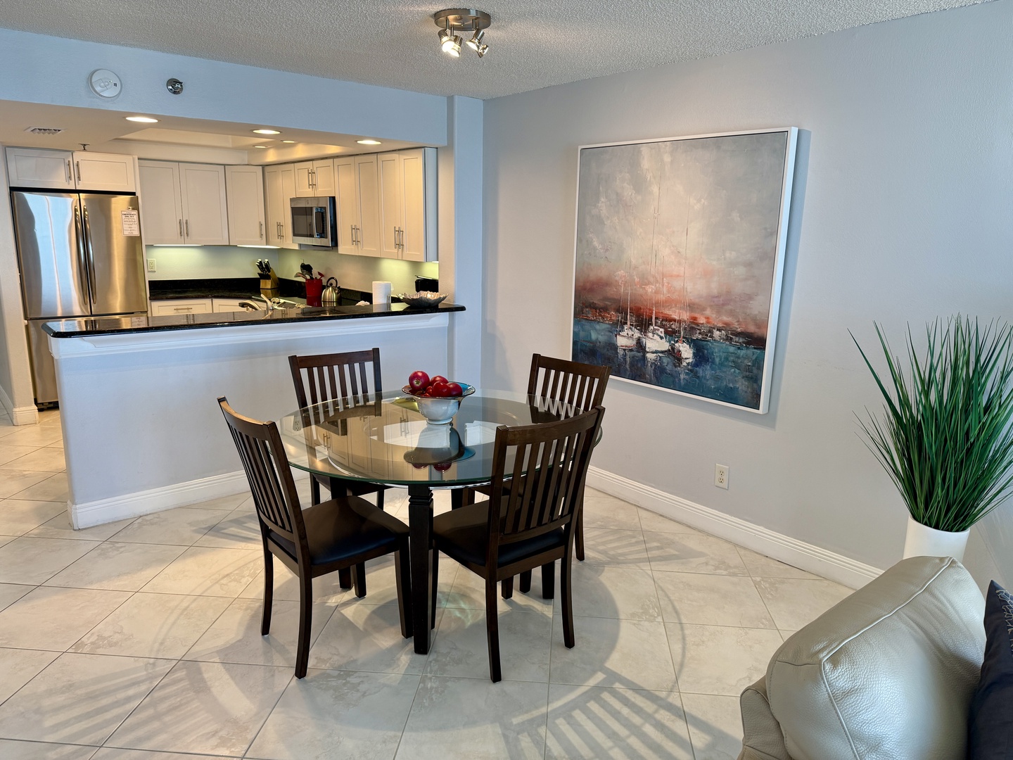 Gather around your stylish glass dining table for memorable meals, with a fully equipped kitchen just steps away for easy entertaining.