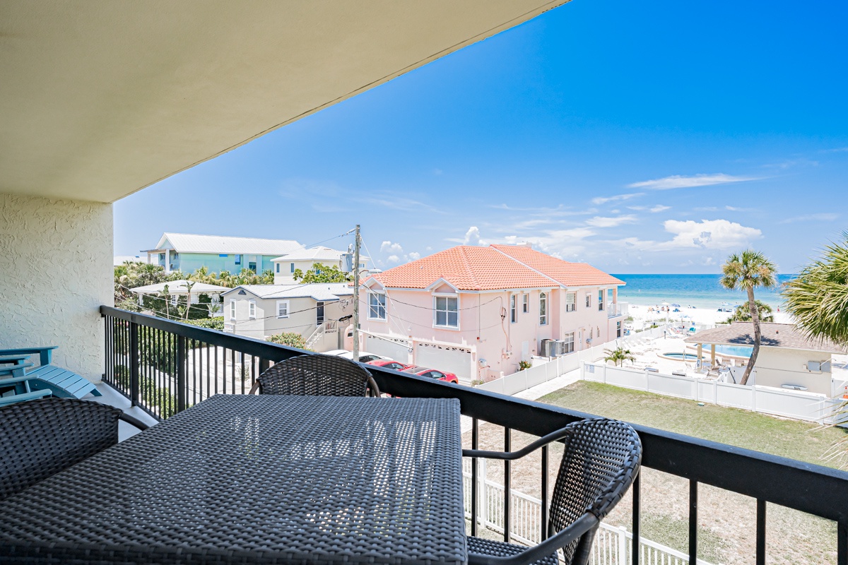 Your private balcony overlooks the sparkling turquoise sea and sun-soaked beach, framed by swaying palms. Enjoy morning coffee or sunset cocktails at your outdoor table with coastal breezes and ocean views.