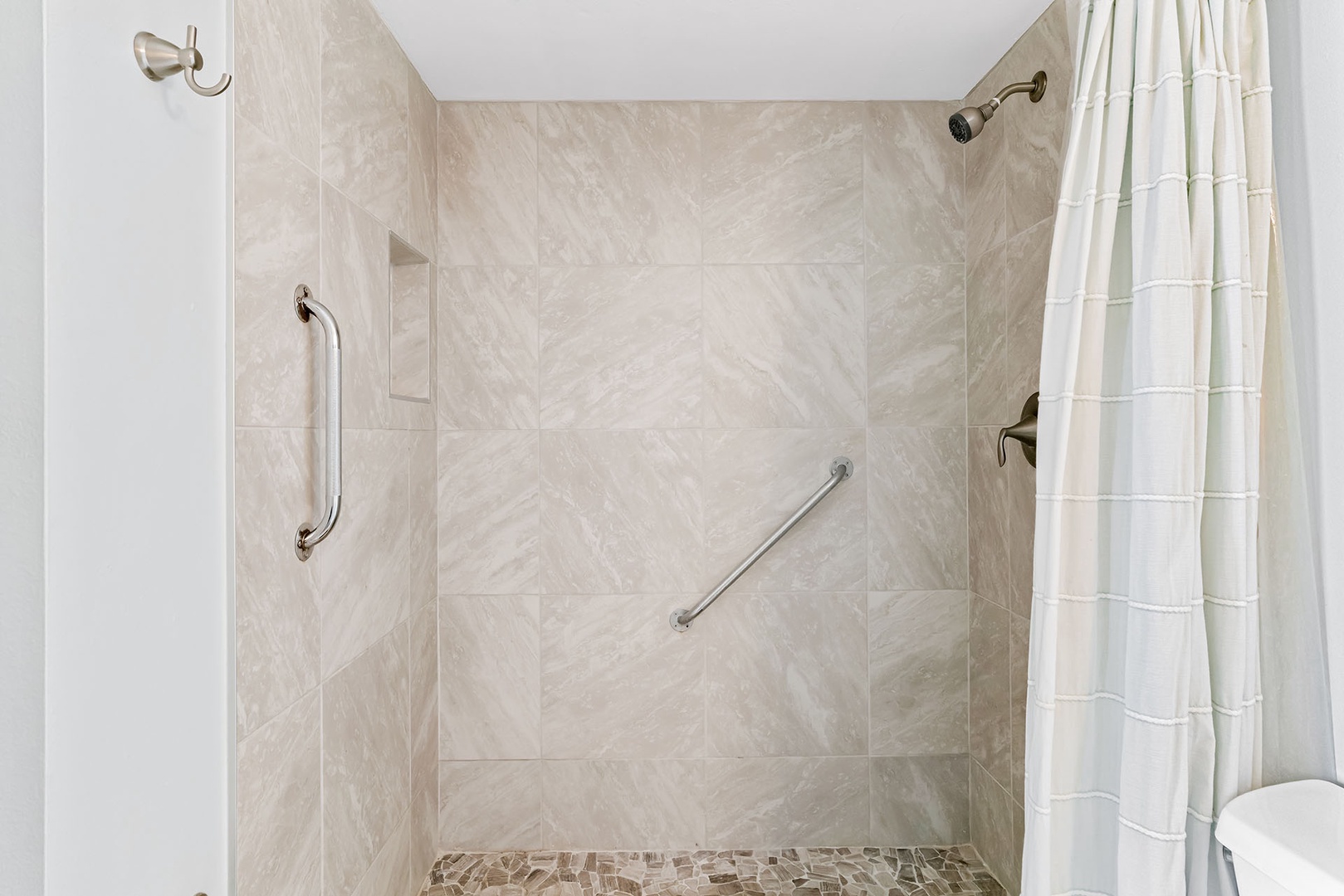 Master shower has grab bars and step-in shower