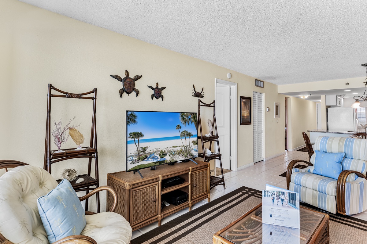 Kick back on the striped chairs and plush white sofa as you unwind in your coastal-themed living space. Charming sea turtle decor and beach-inspired accents set the scene for a relaxing getaway.