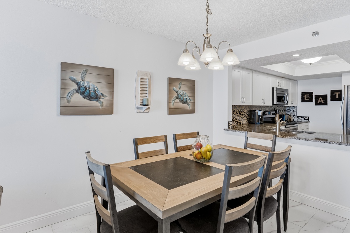 Gather around your stylish dining table for memorable meals, with coastal artwork setting a relaxing tone and your fully equipped kitchen just steps away.