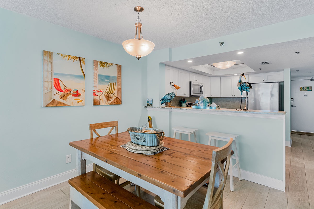 Your bright dining space flows seamlessly into the fully equipped kitchen, perfect for memorable meals with coastal charm.