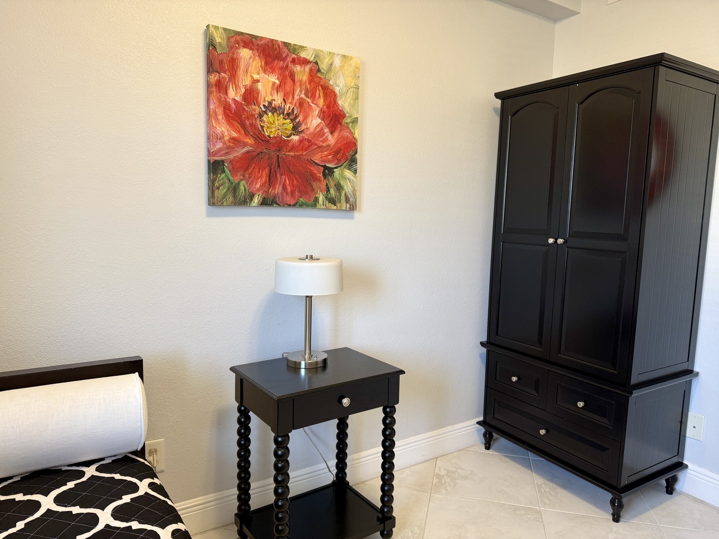 Your comfortable bedroom features elegant black furniture and warm touches, creating the perfect retreat for restful nights.